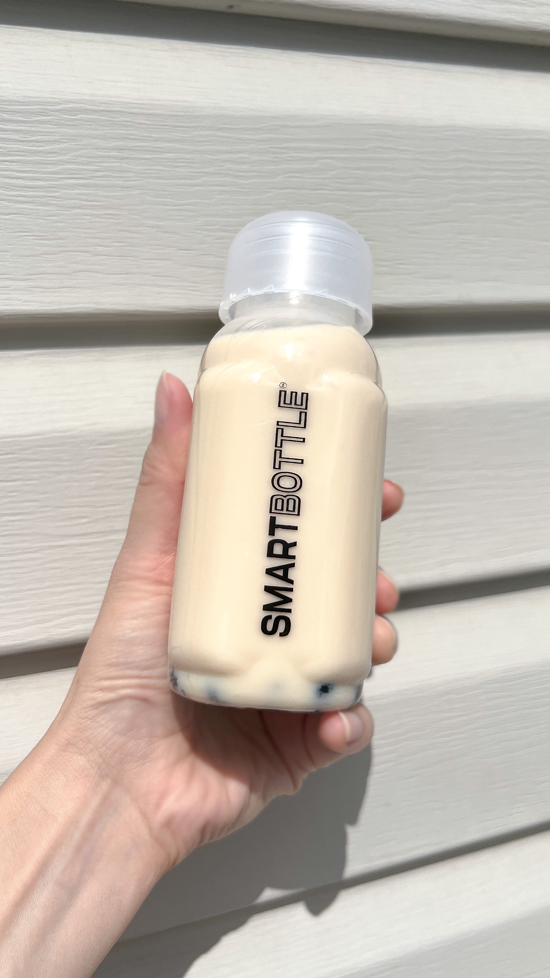 Hand holding a Smartbottle 250ml with milk 